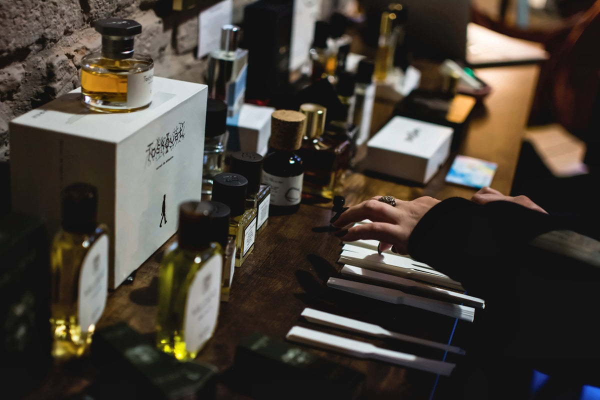 Perfume bottles and testing strips on a table at a Vetiveria event